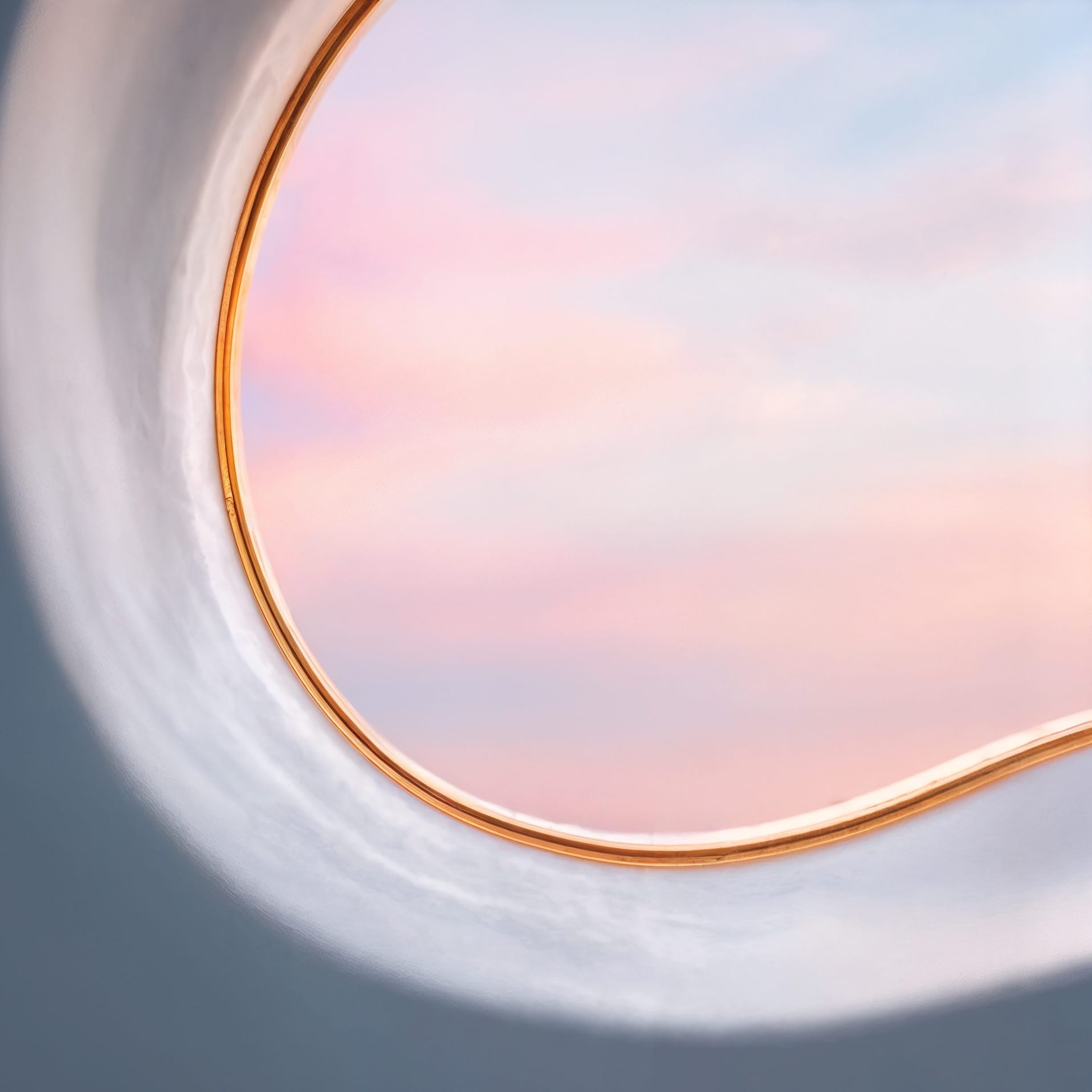 Macro of the gold-lined aperture and the sky beyond
