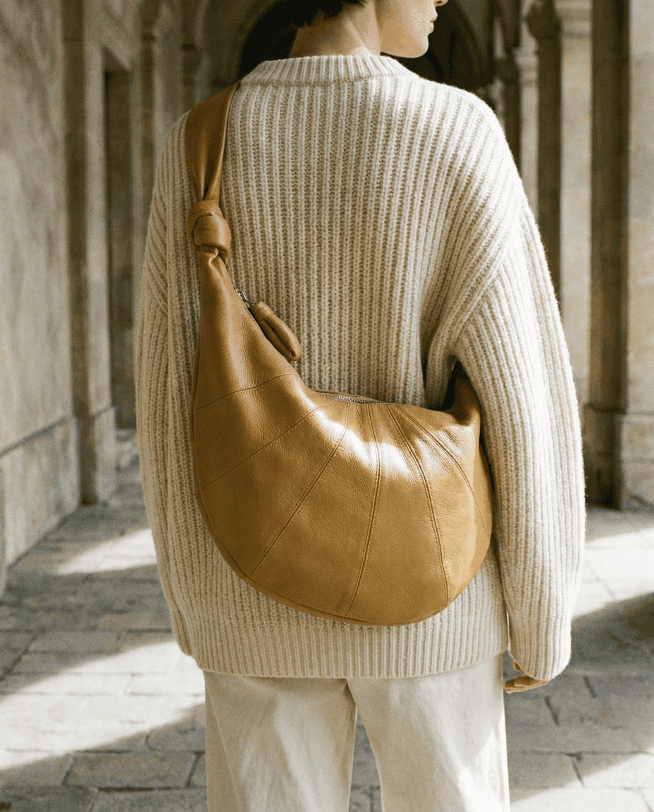 Lemaire — back view, leather bag across a ribbed sweater