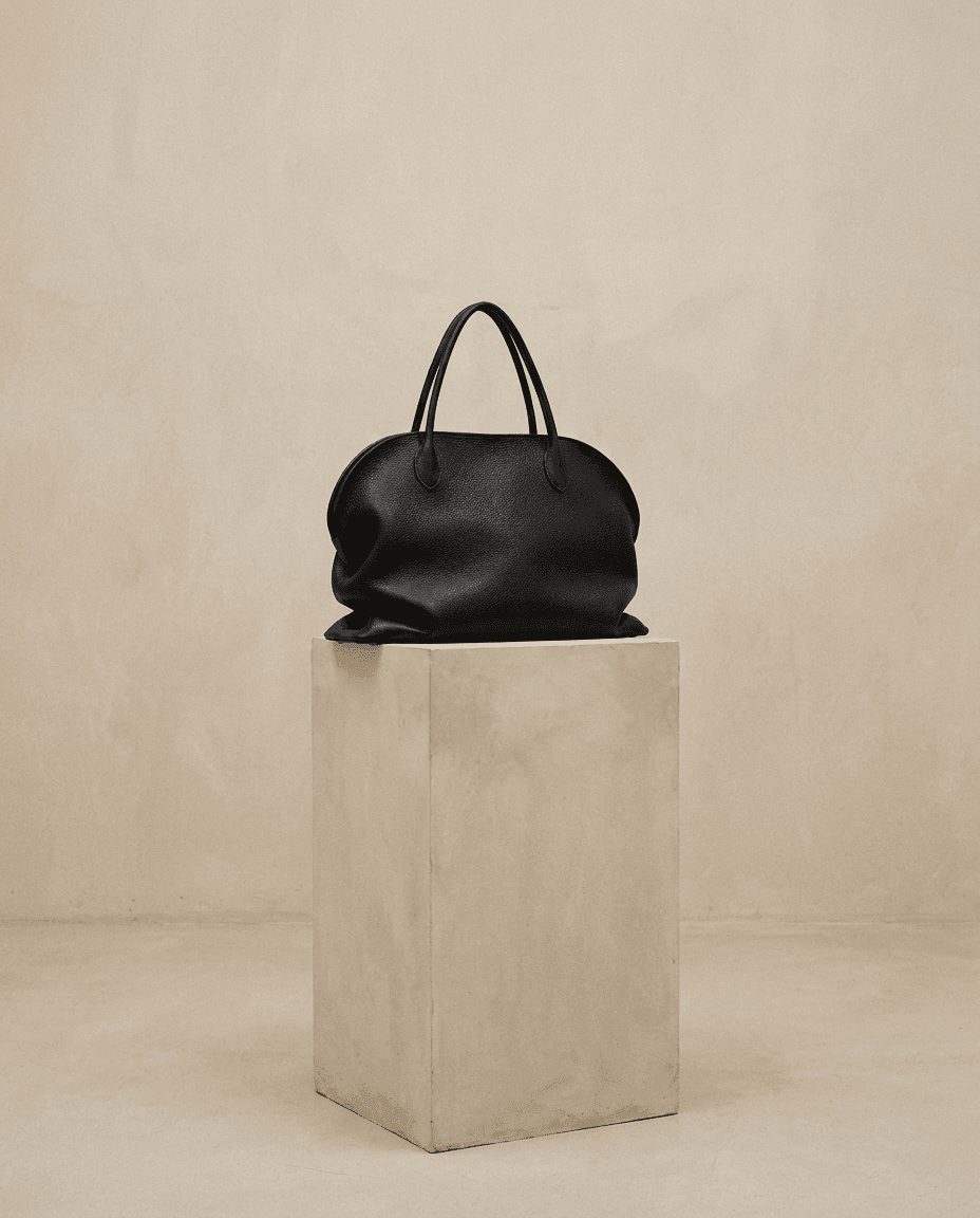 The Row — leather bag on a concrete plinth